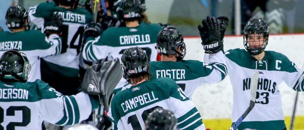 Nichols College Men's Hockey Captain high fiving his teammates