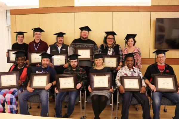 Students posing with their business certificate program certificates